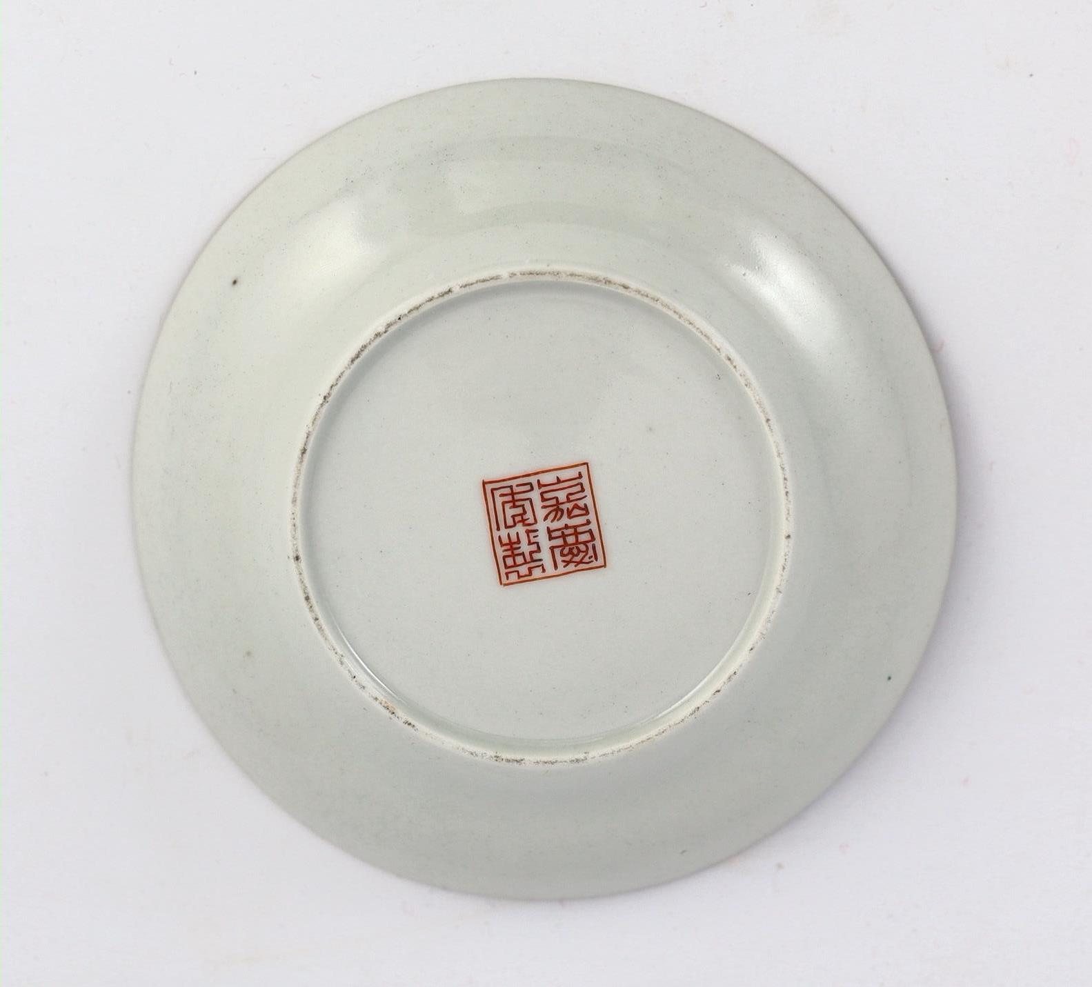 A Chinese famille rose fencai ‘dragon’ saucer dish, Jiaqing four character seal mark, 19th century, 14.6cm diameter